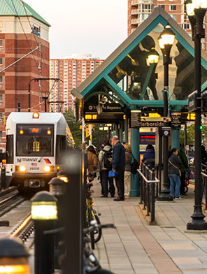 NJ Transit Rail Station at Harborside in Jersey City with busy platform and train arriving.